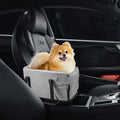 The console dog car seat inside a car containing a dog.